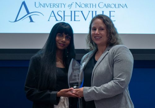 2 people in front of the stage in the Blur Ridge room