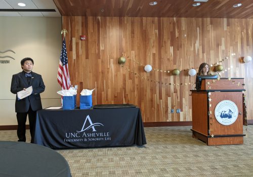 Students speaking at a formal greek life event