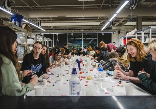 Students painting at a table