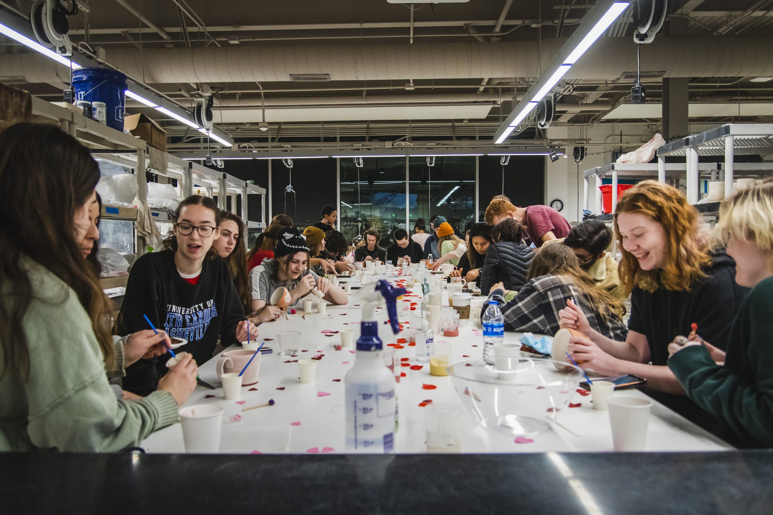Students painting at a table